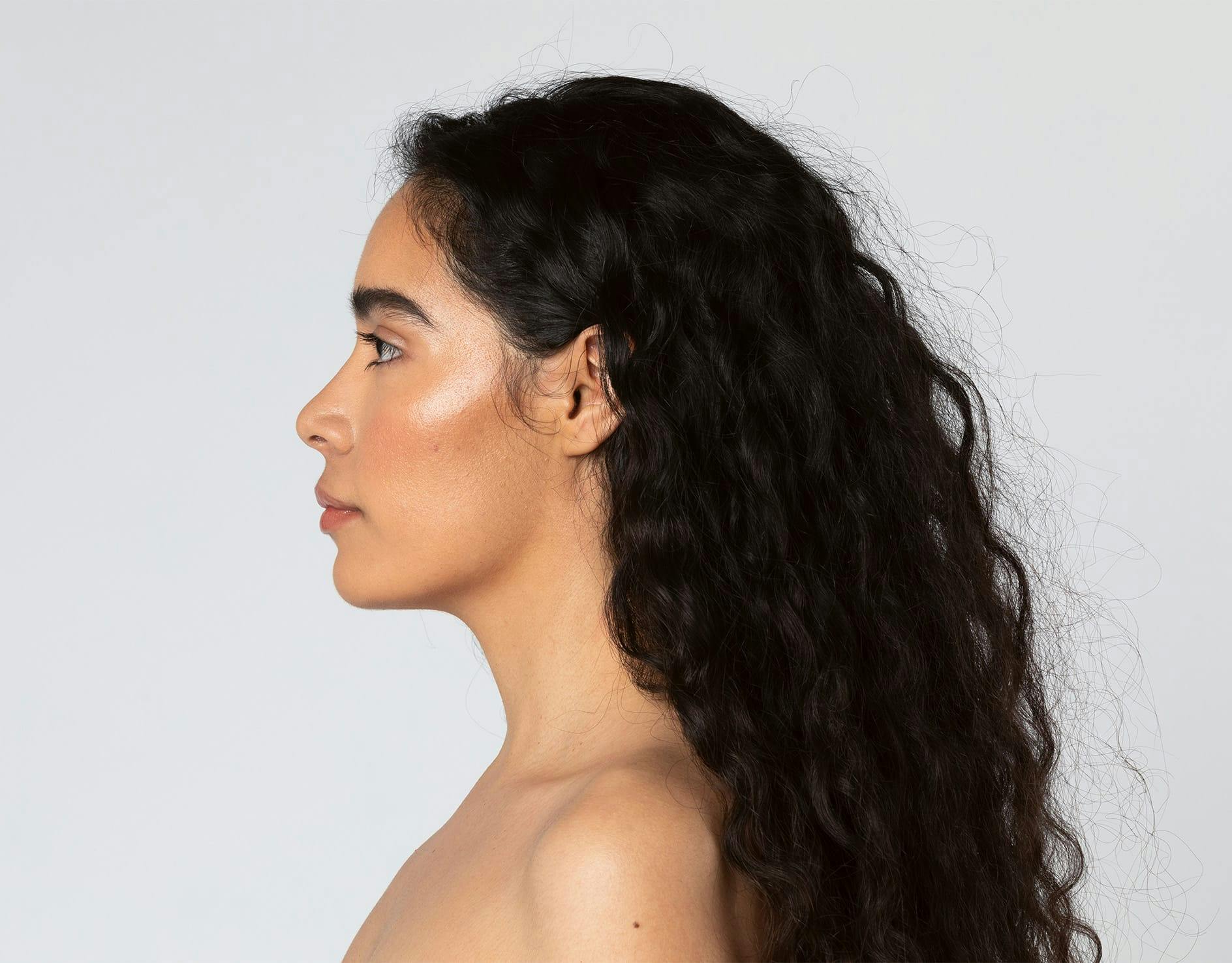 woman sitting with hand near face