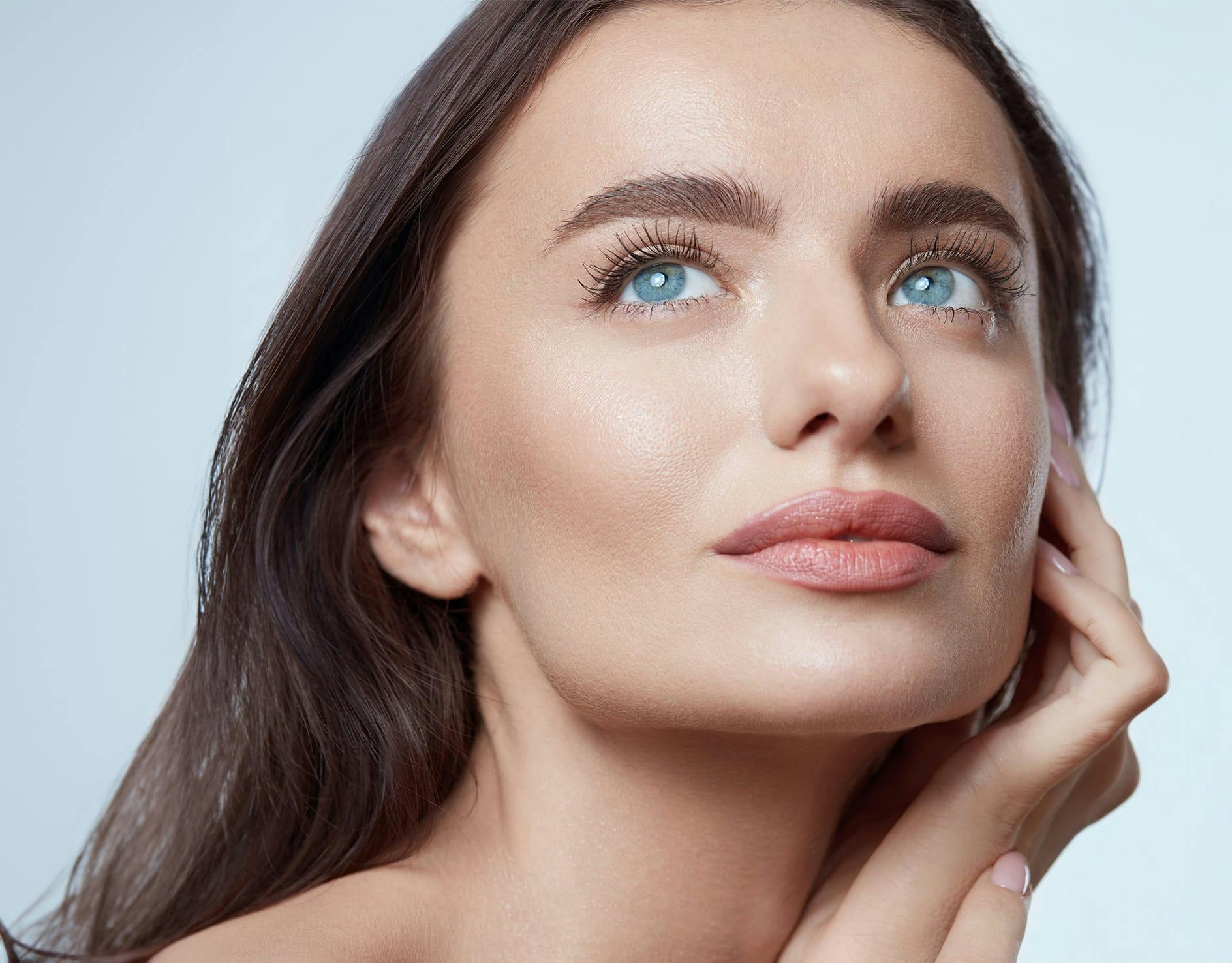 woman cradling face with hands