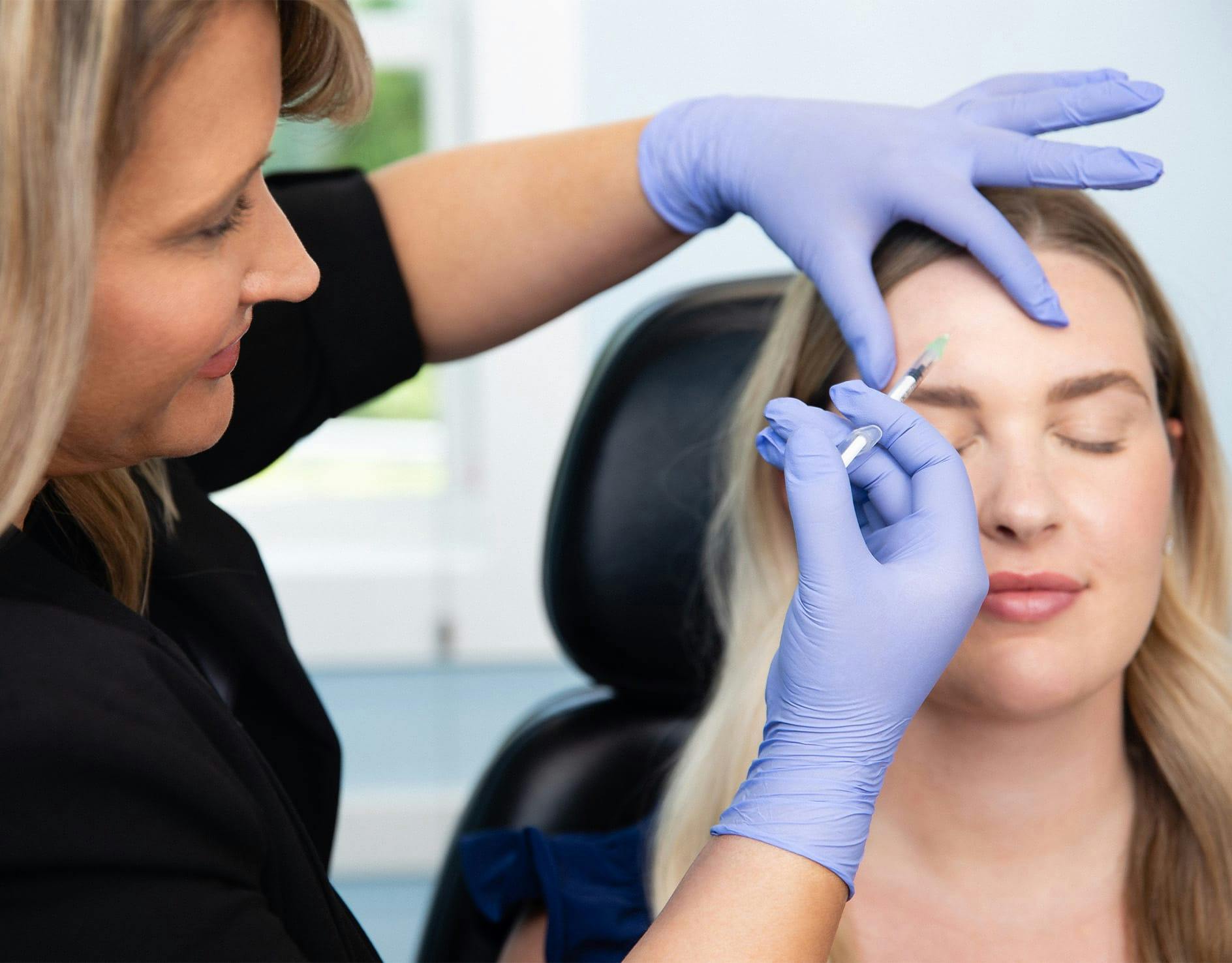 smiling woman with her fingers at her temples