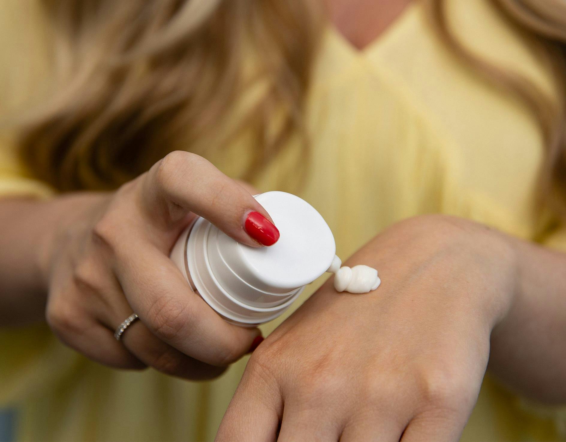 skincare product being applied to hand