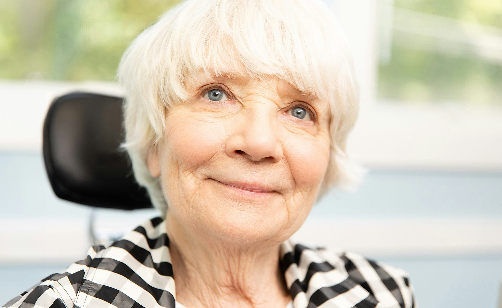 smiling woman with hand at face