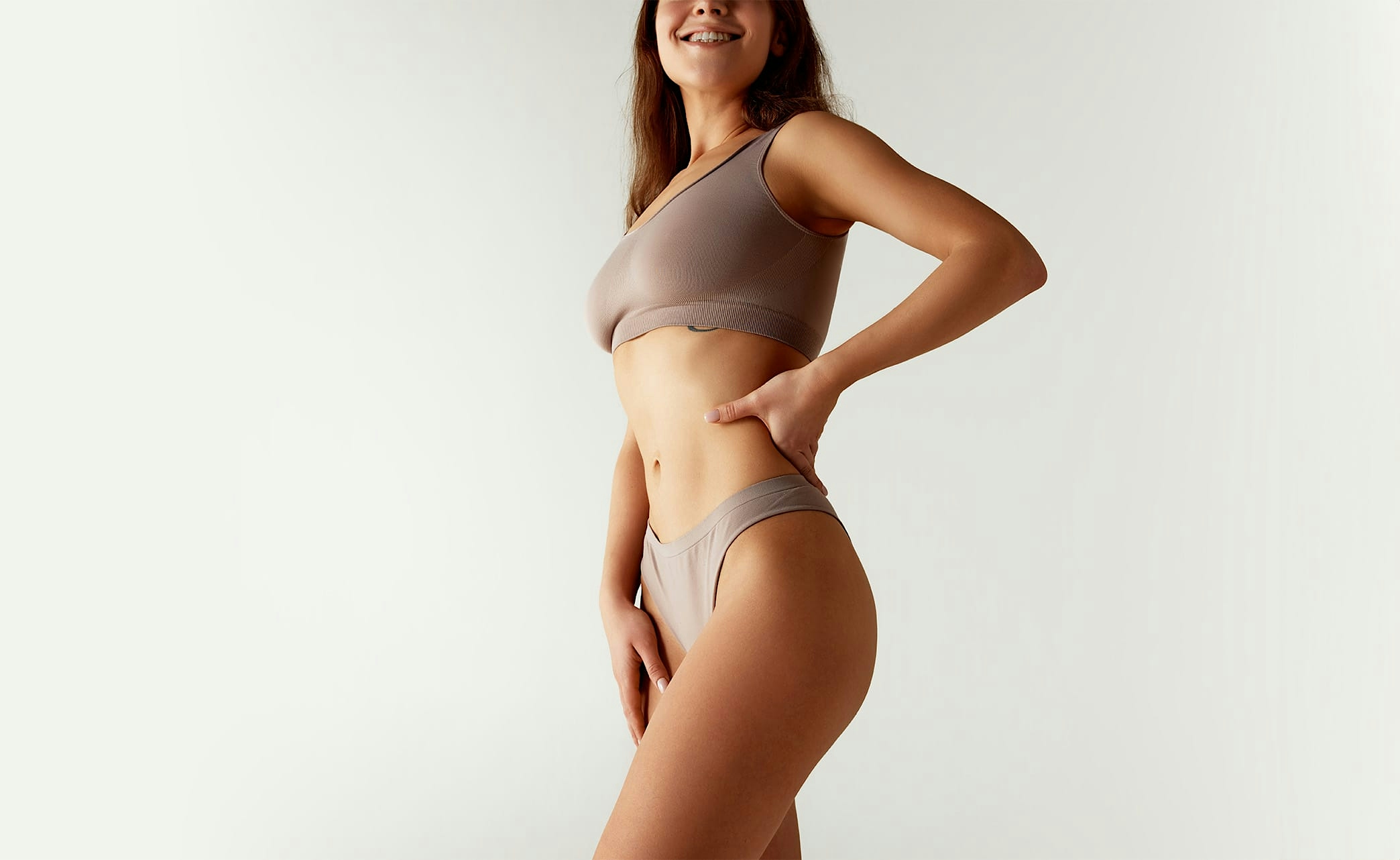 woman with eyes closed holding arms above head