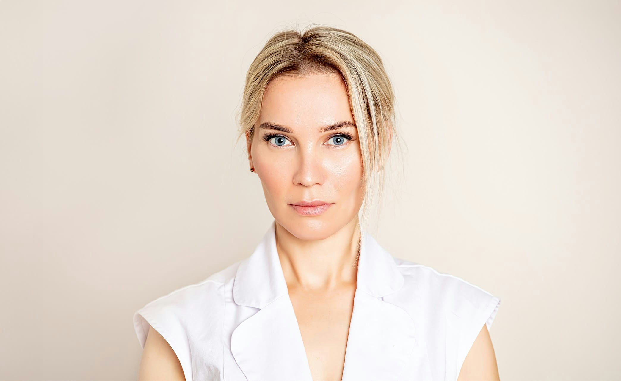 woman with blonde hair wearing a white top