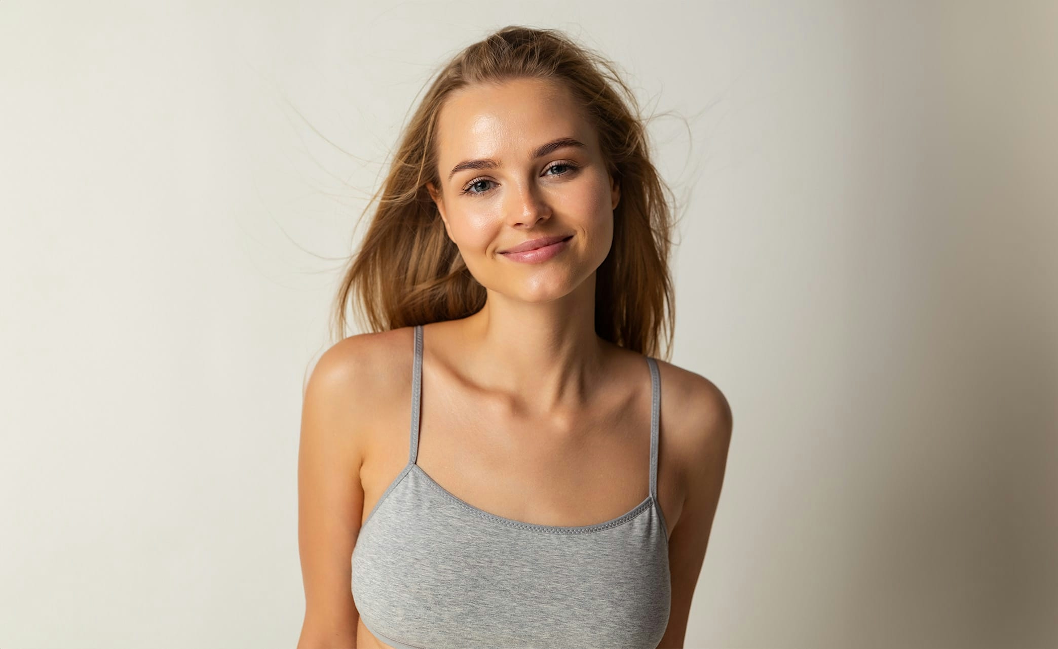 woman with long blonde hair smirking