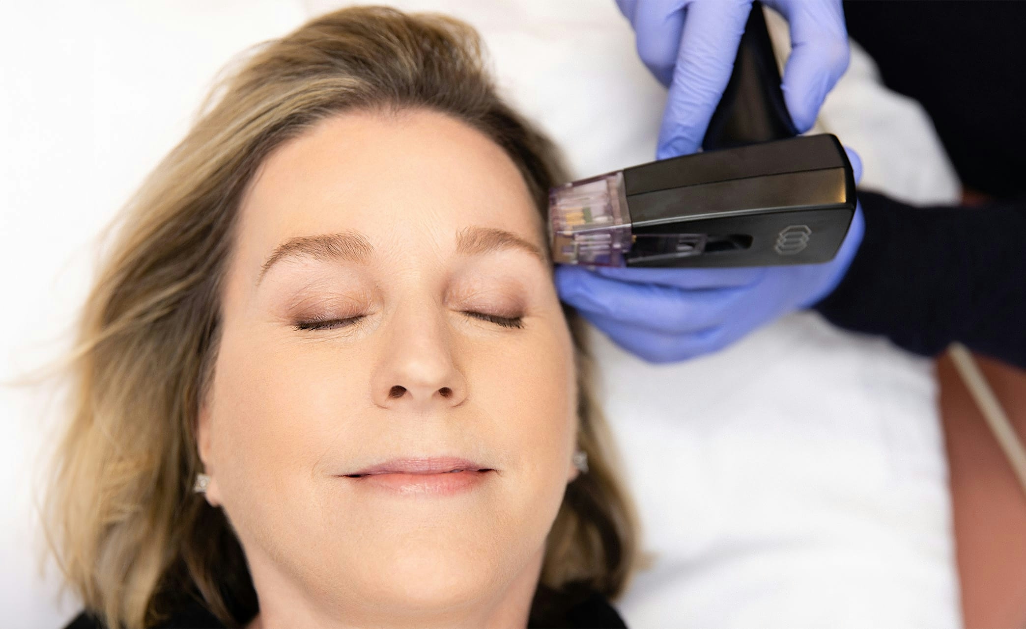 smiling woman cradling face