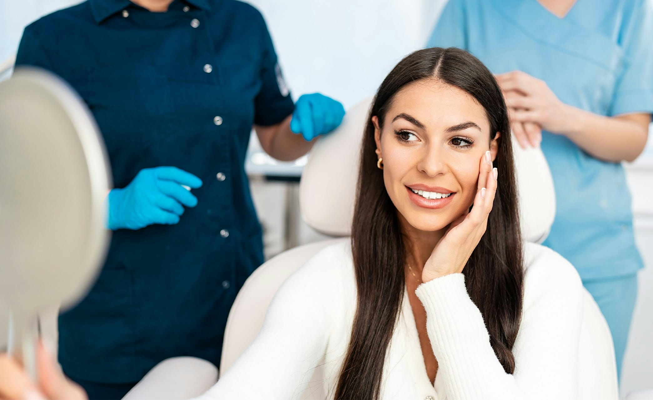 woman looking at herself in a handheld mirror