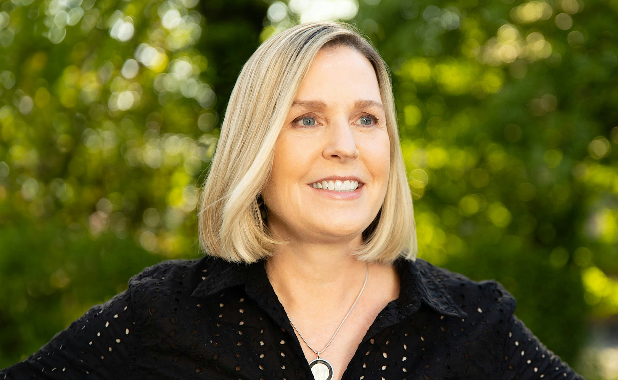 smiling woman with hands together