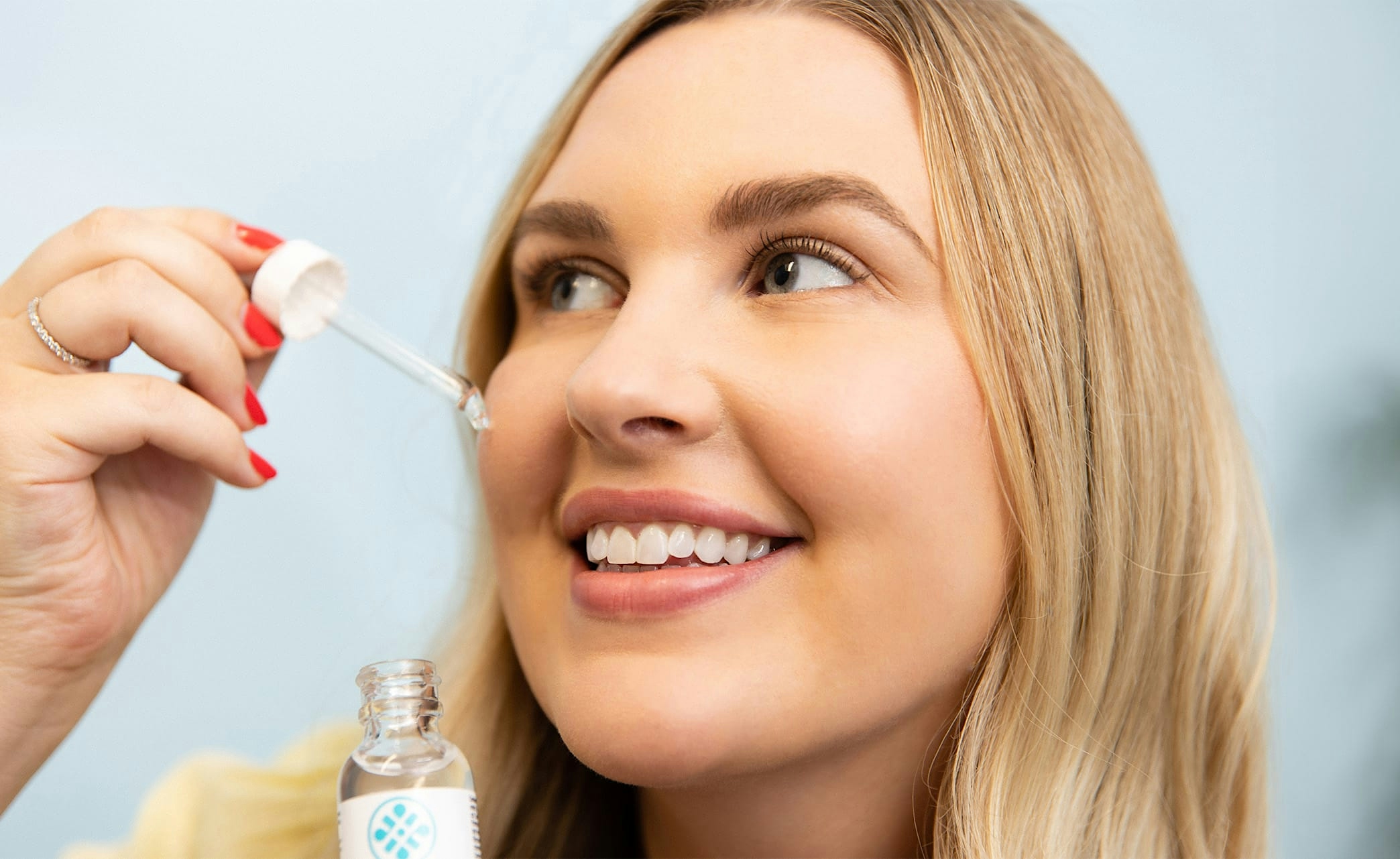 patient applying skincare product