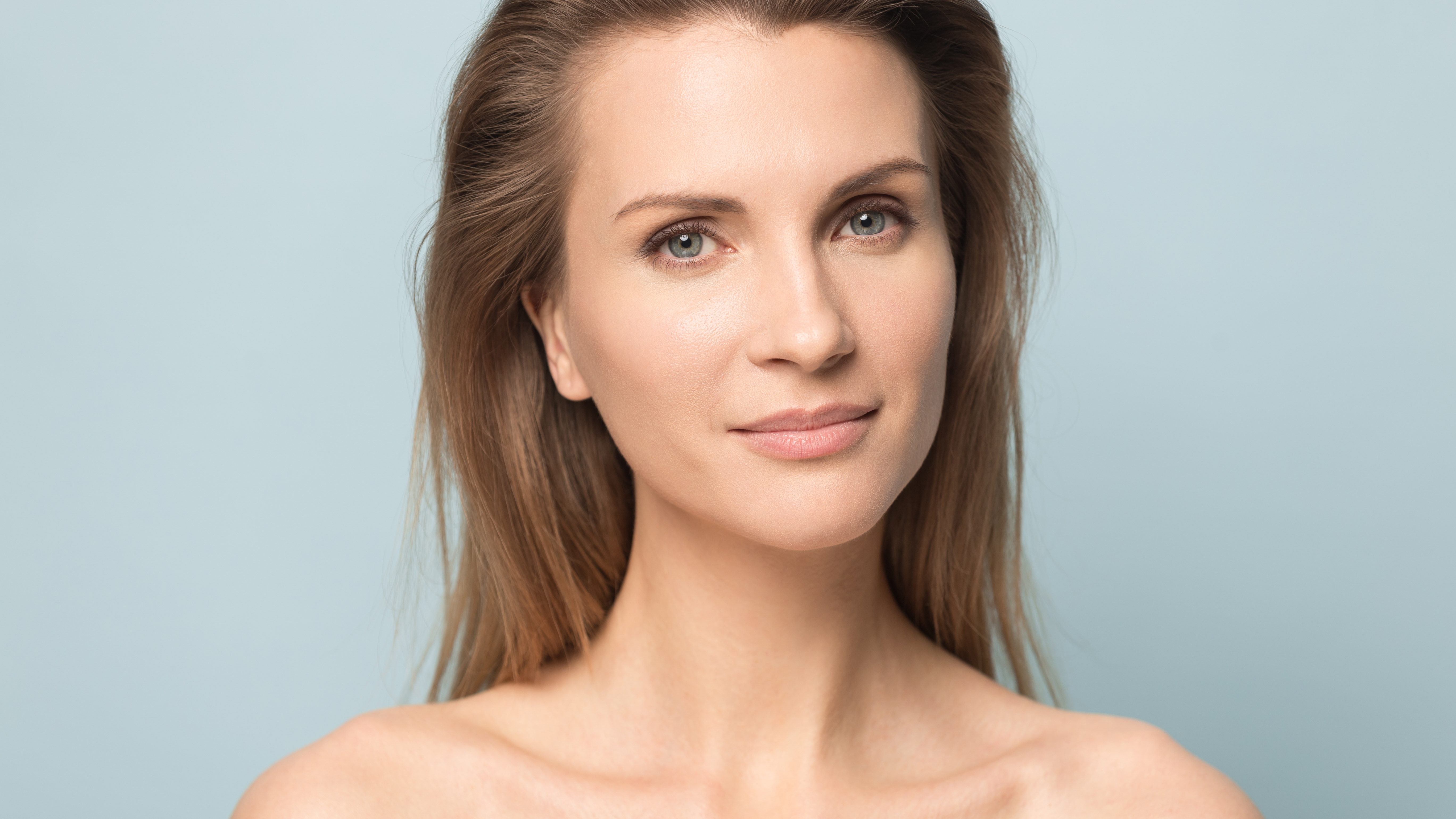 Woman smiling with blue background