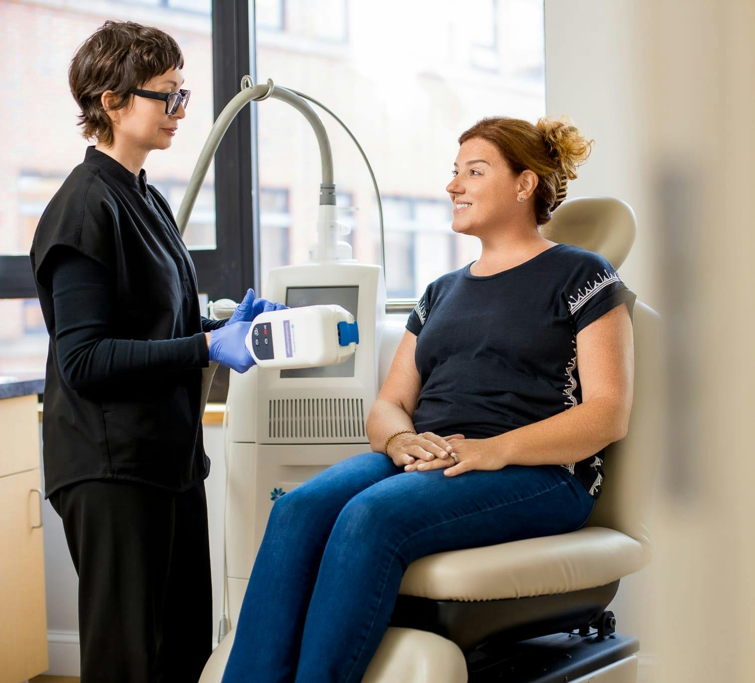 Nurse treating patient with device