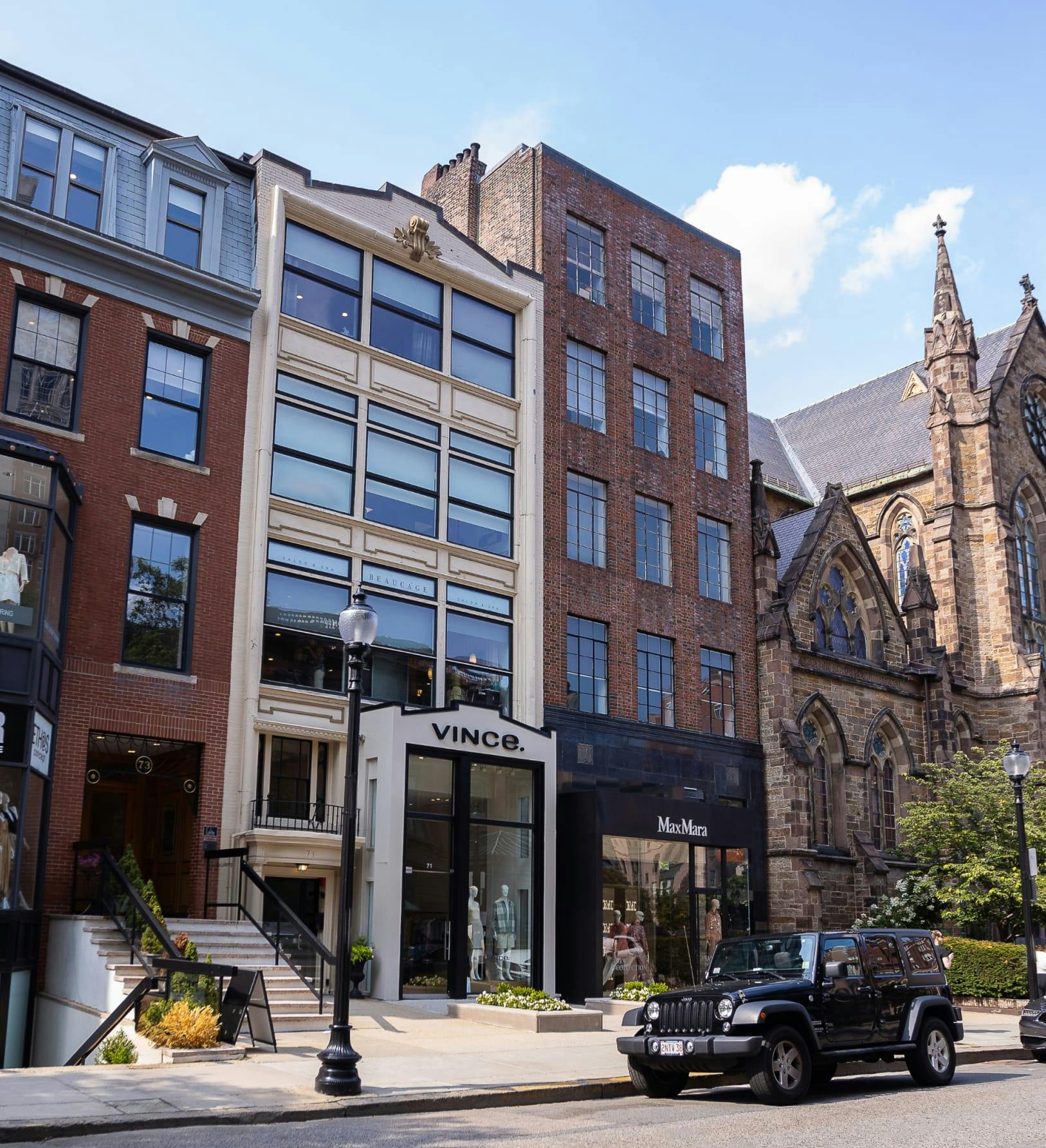 Photo of buildings with jeep parked out front