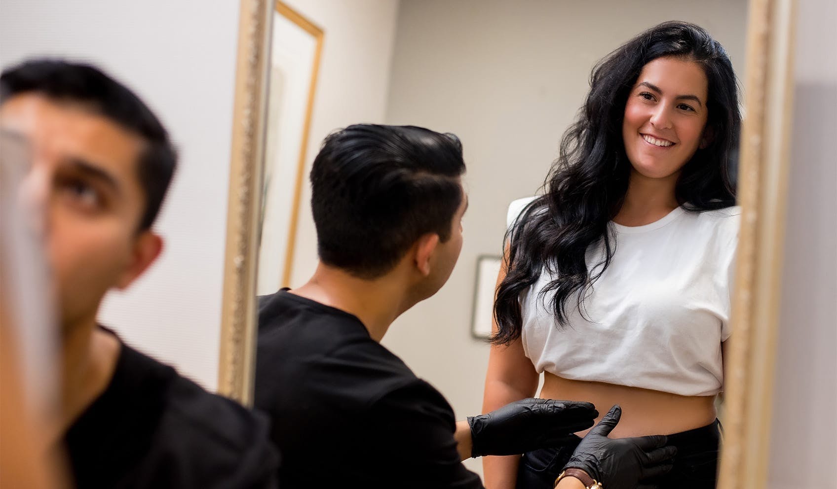 patient smiling and standing in front of mirror