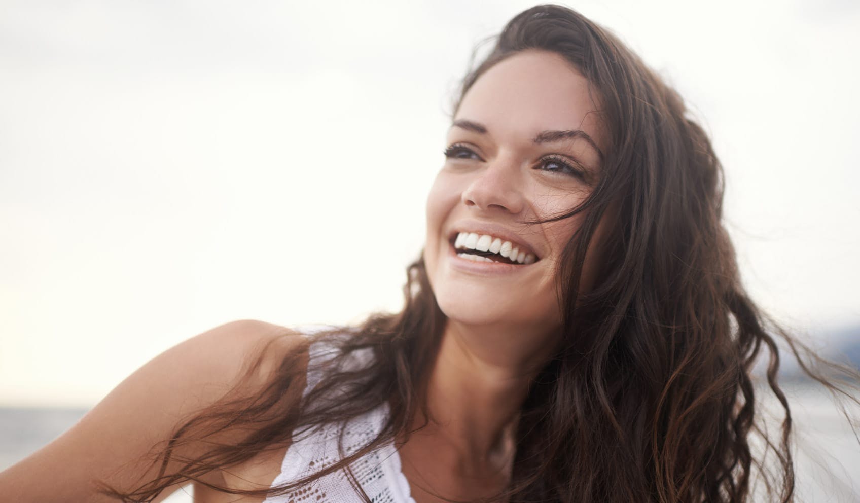 woman smiling and looking off into the distance
