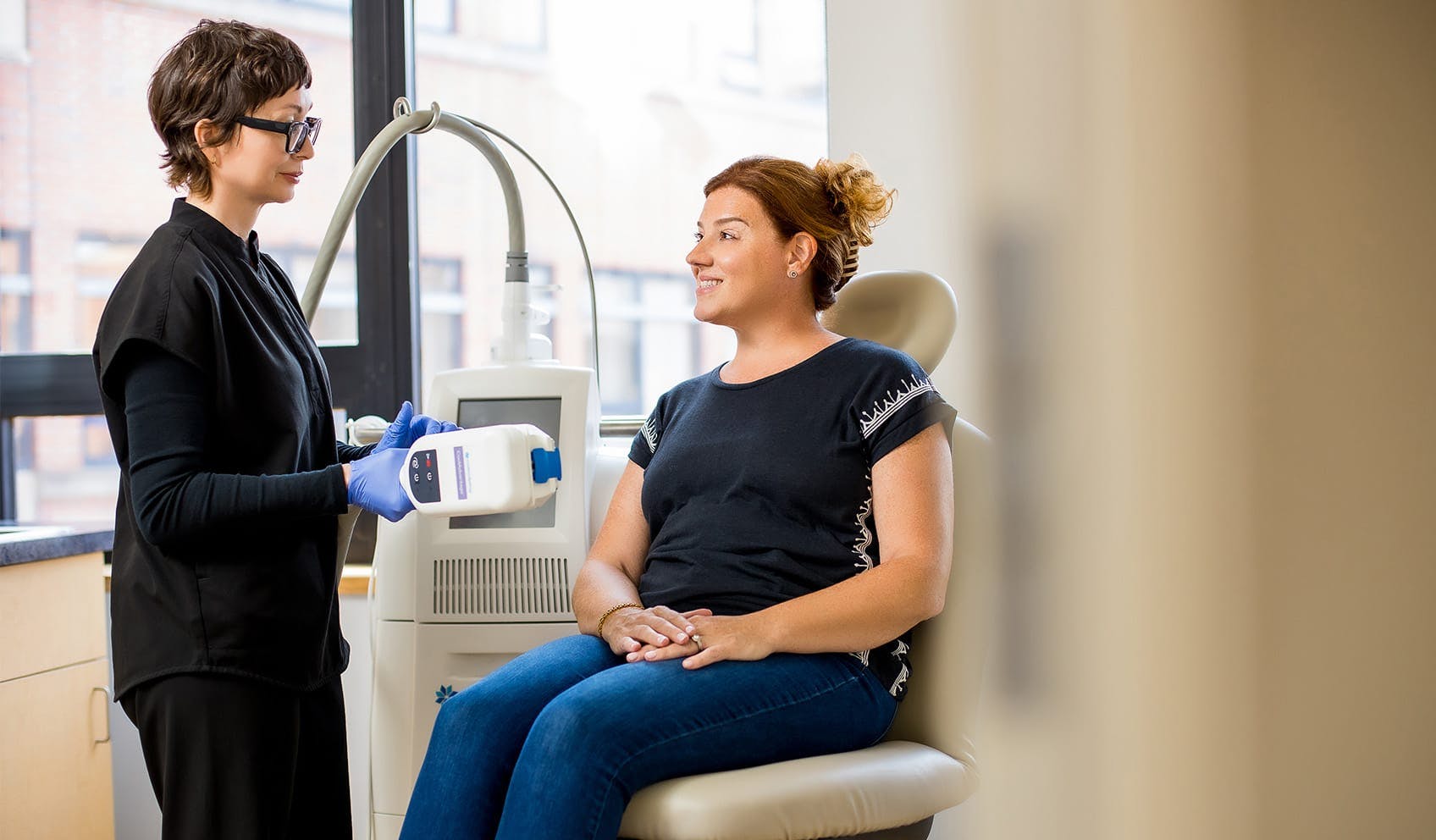 smiling patient receiving coolsculpting treatment