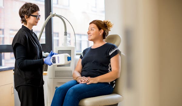 smiling patient receiving coolsculpting treatment