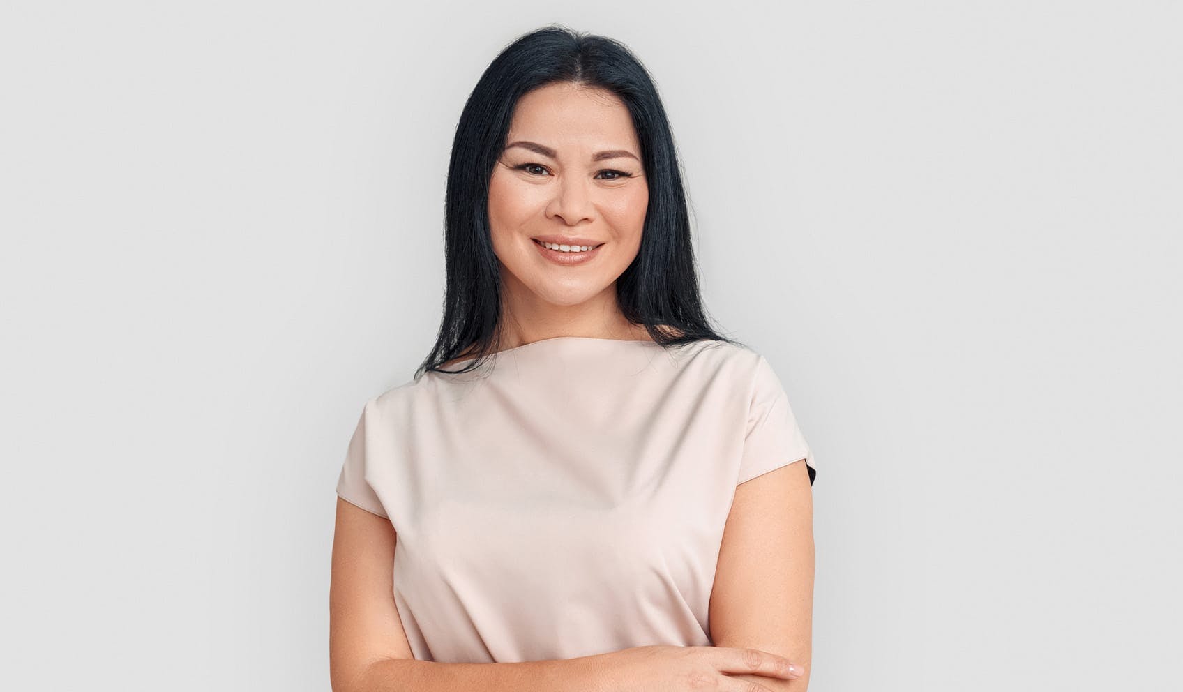 Woman smiling and crossing arms