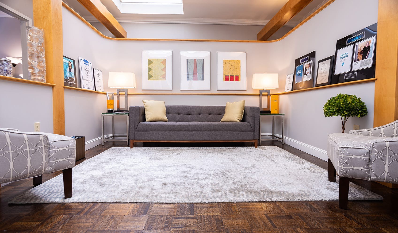 Boston Center for Facial Rejuvenation patient waiting room with couch and chairs