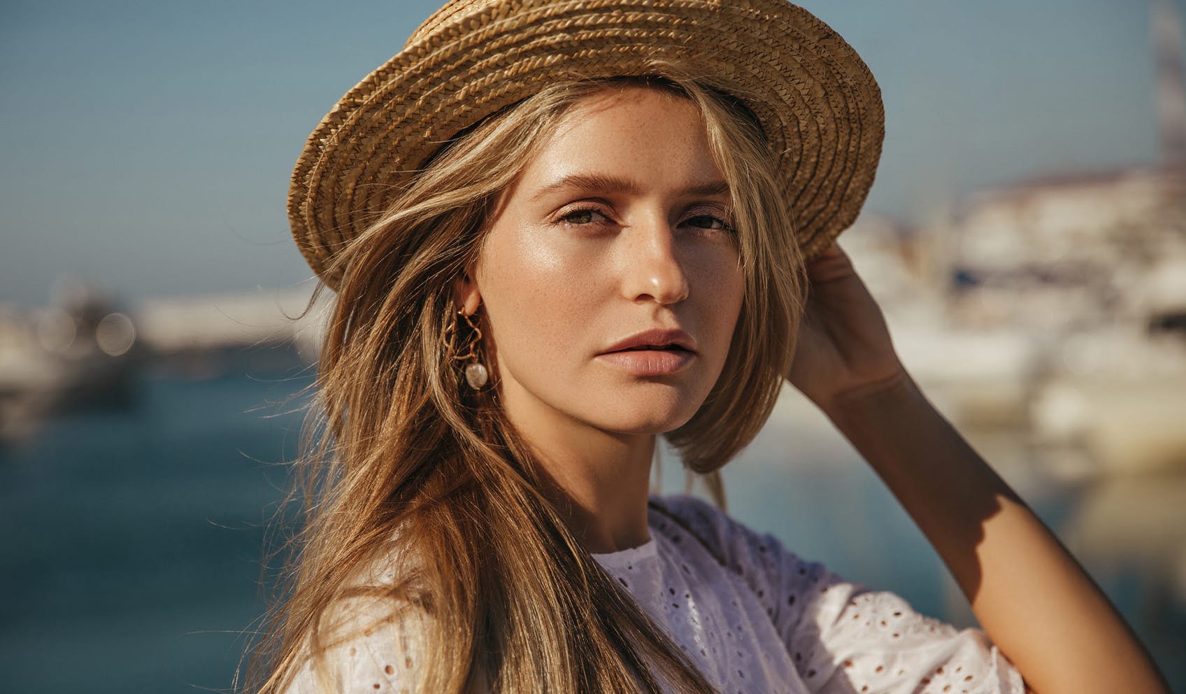 Beautiful woman staring off into the distance wearing straw hat