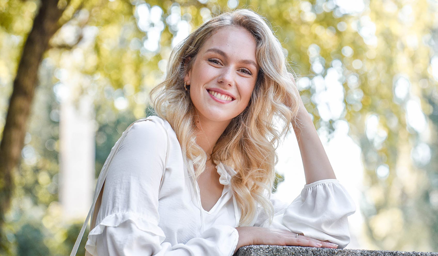 Woman smiling in the outdoors resting head