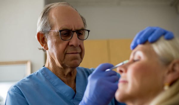 Dr. Miller treating patient with injectables