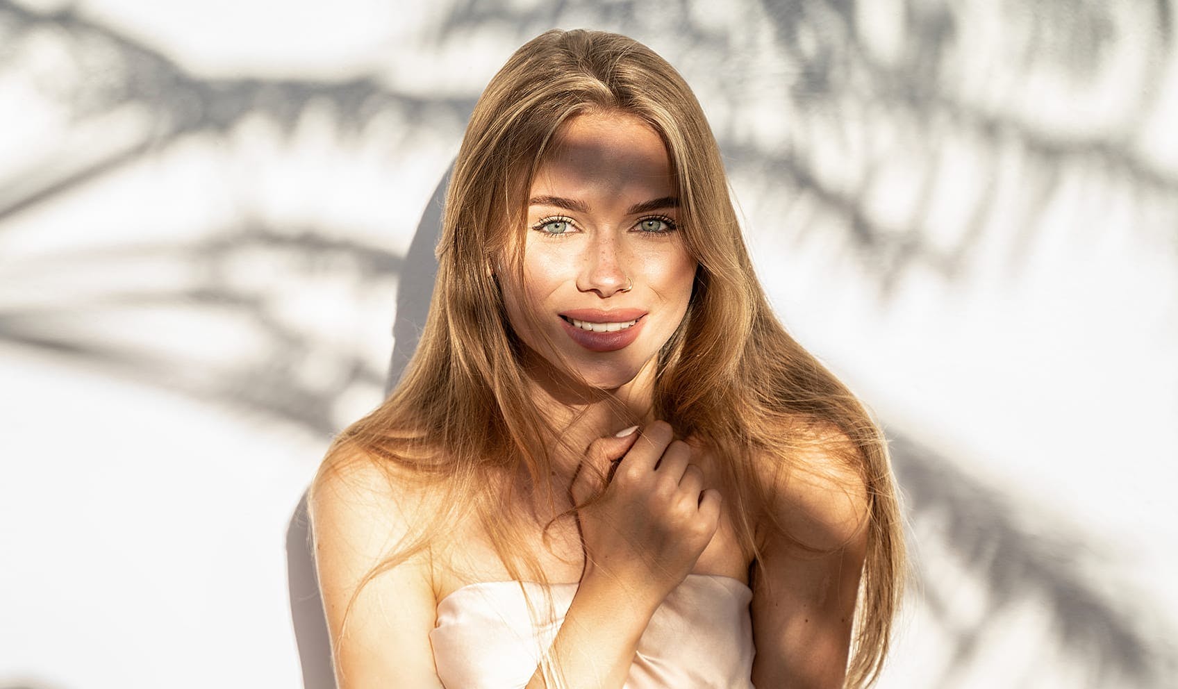 Woman smiling with arm on chest