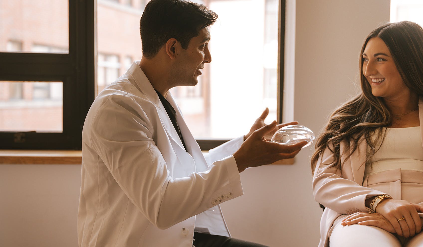 Dr. Doherty showing patient a breast implant