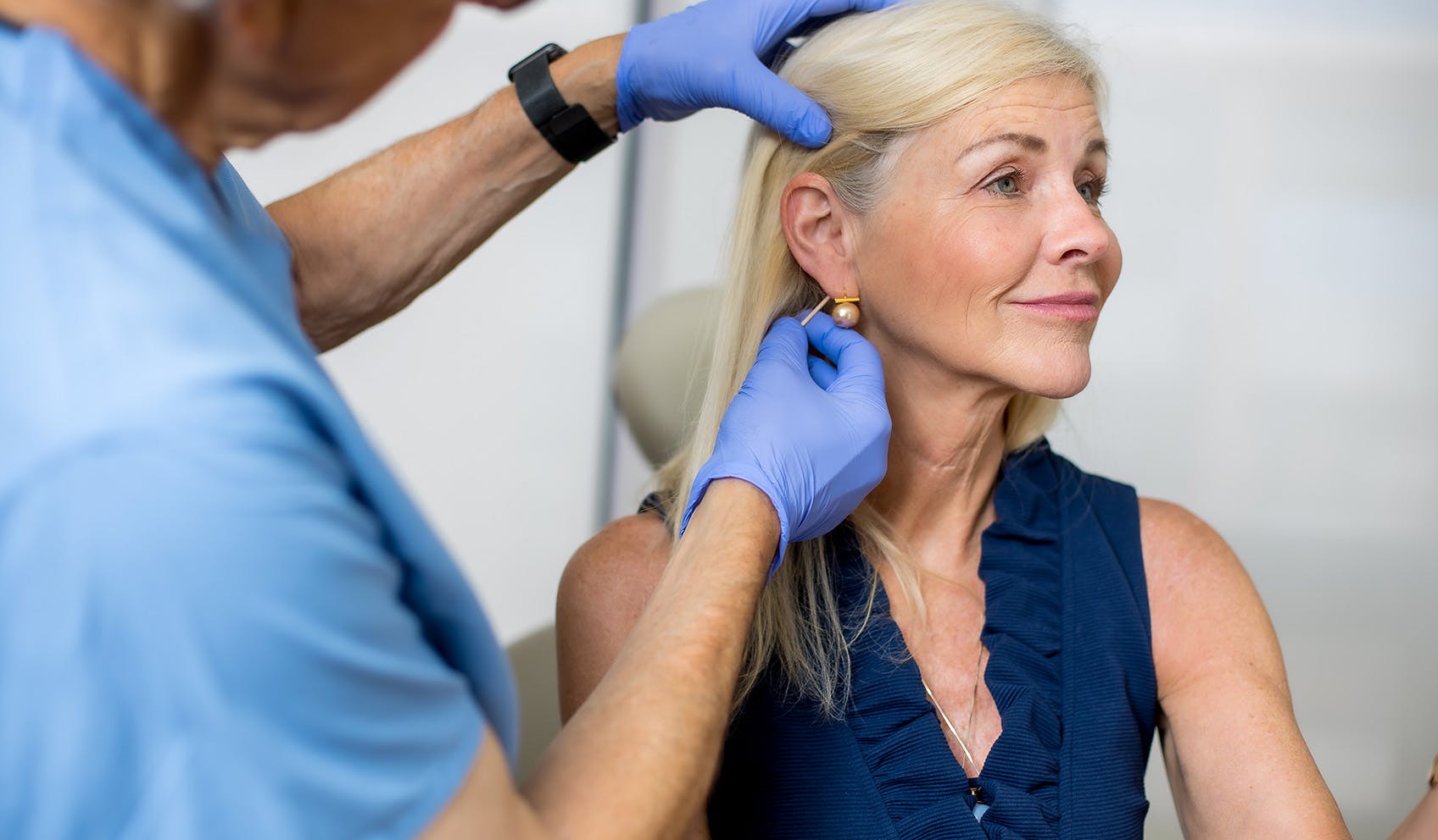 Patient smiling and while doctor is analyzing her face