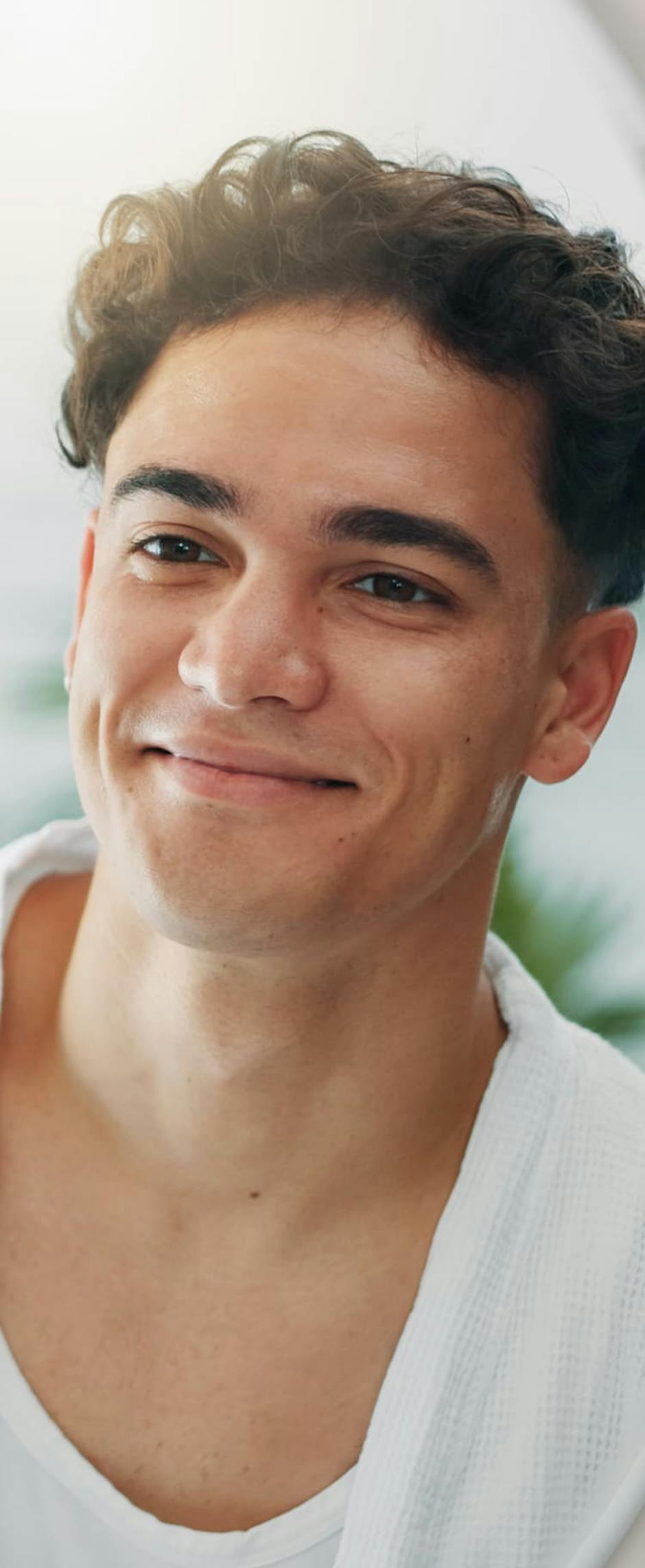 Man with curly hair smiling