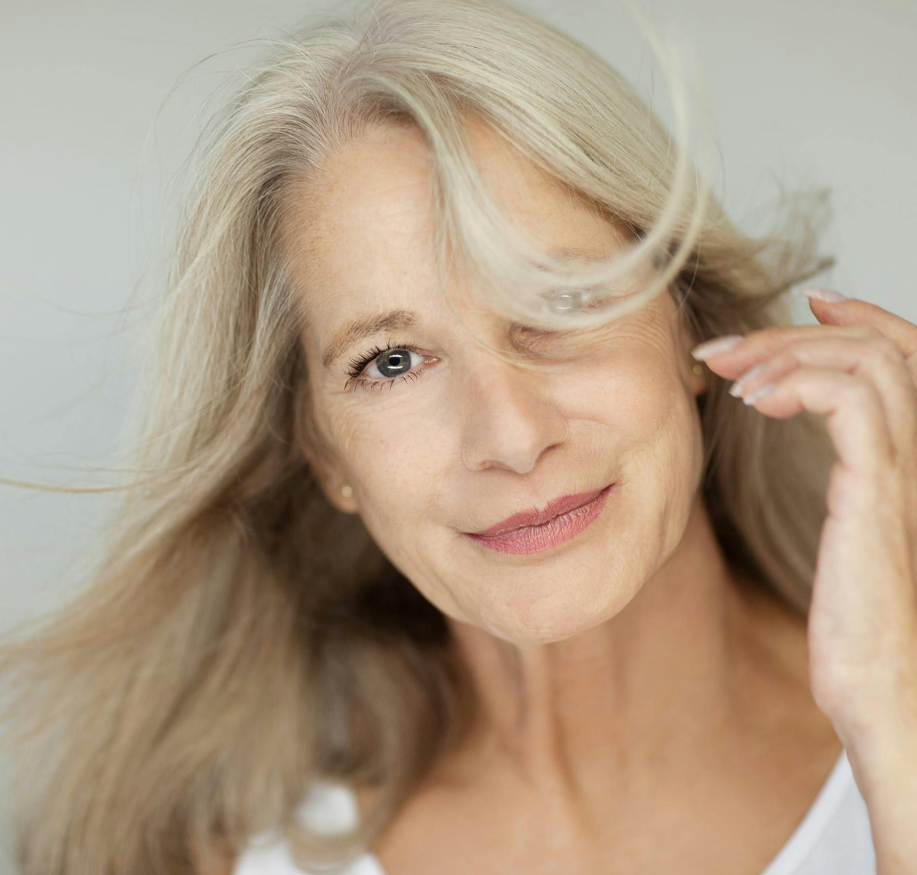 older woman with hair blowing in wind