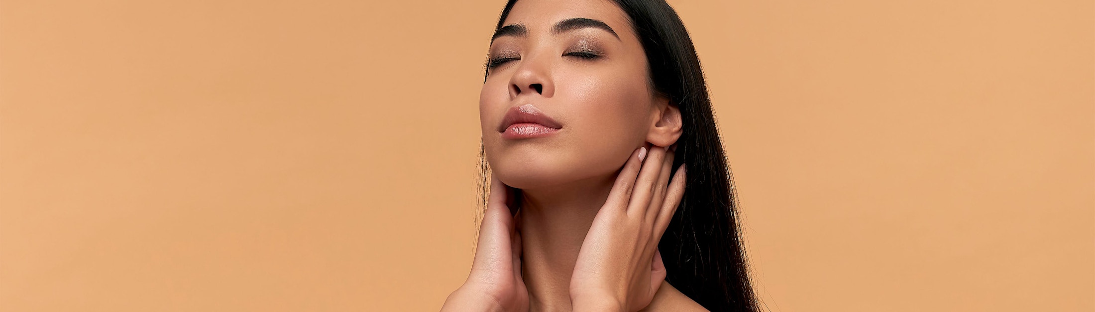 woman touching her neck