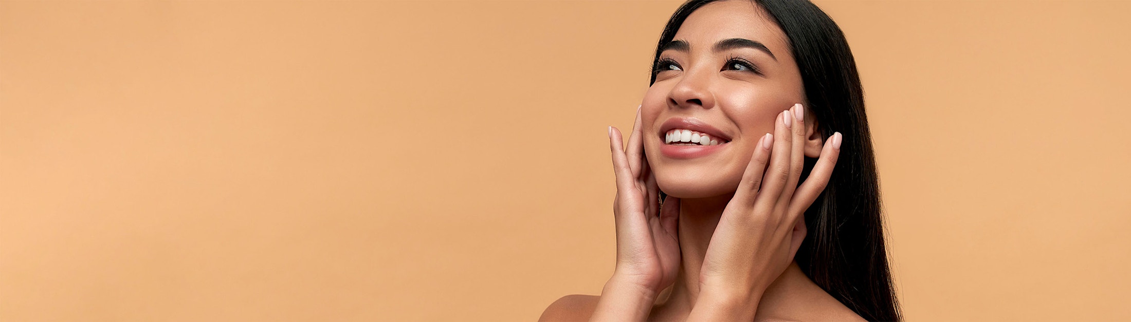 hands on cheeks happy milky orange background