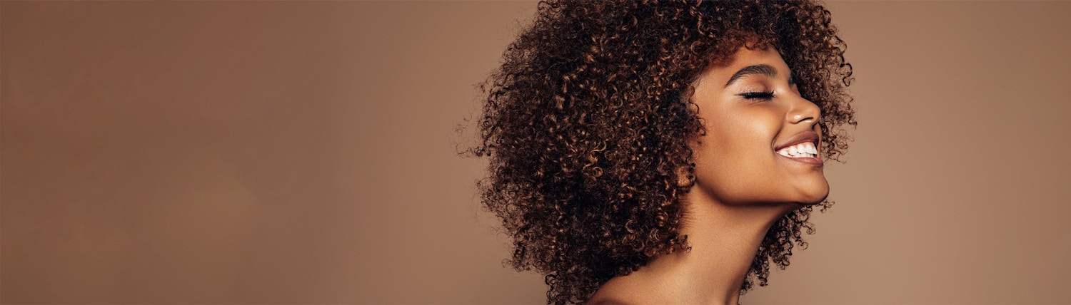 smiling to the side brown background