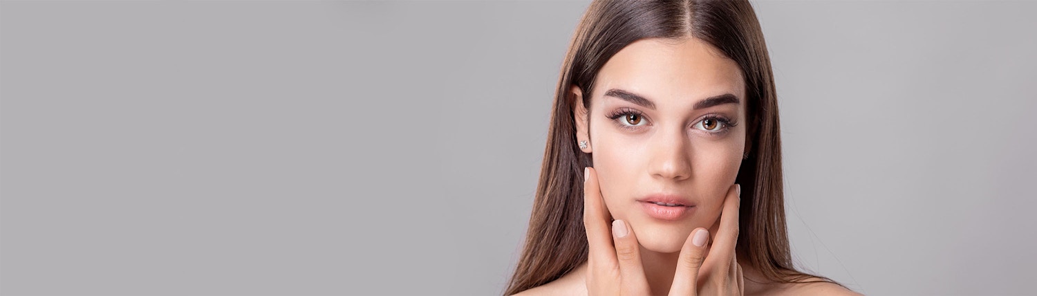 hands on cheeks gray background