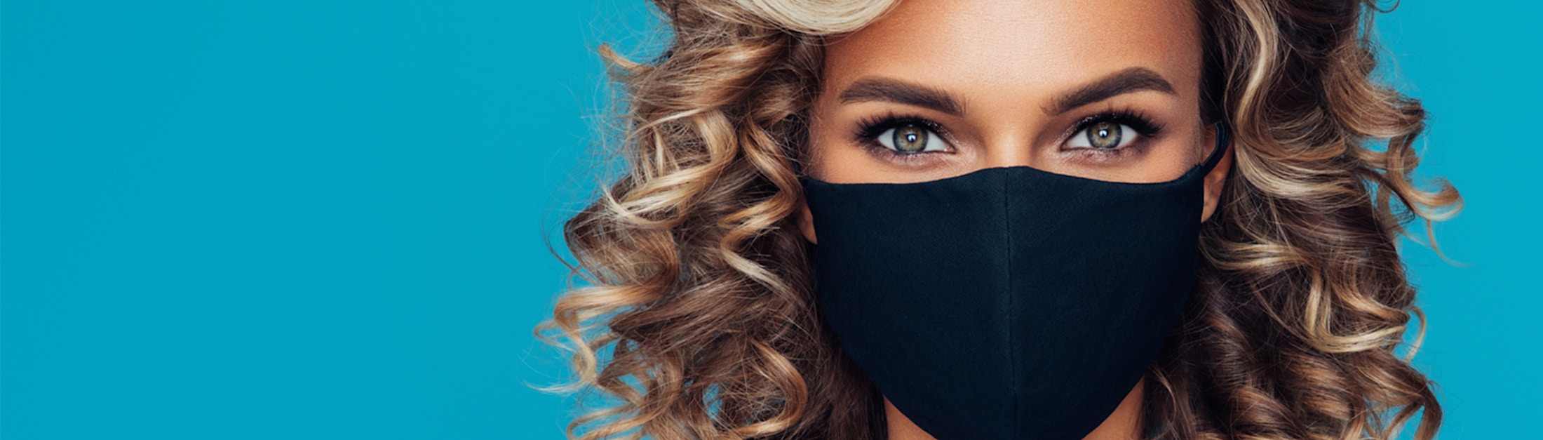 a close up of a woman with a black mask on her face