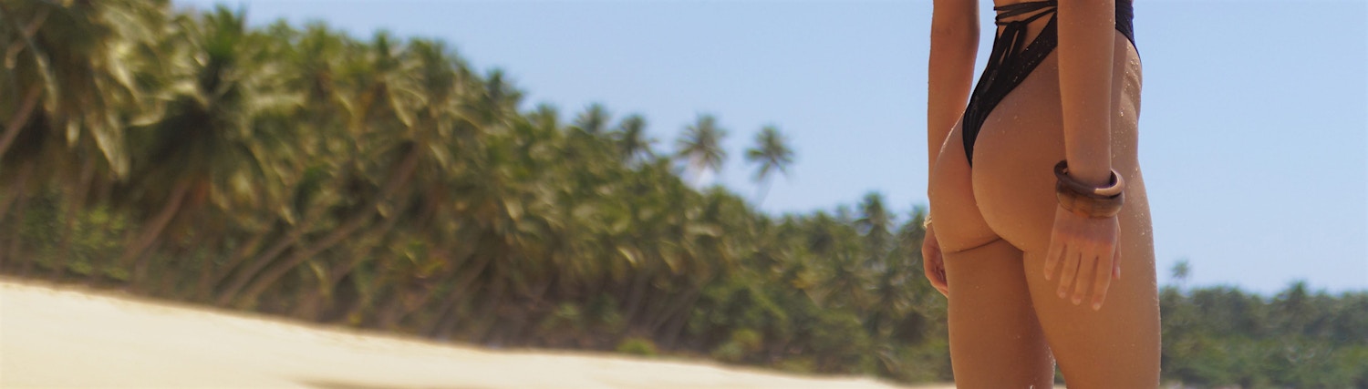 arms crossed behind back green background