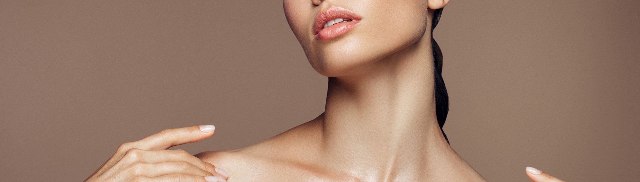 woman touching her collarbones