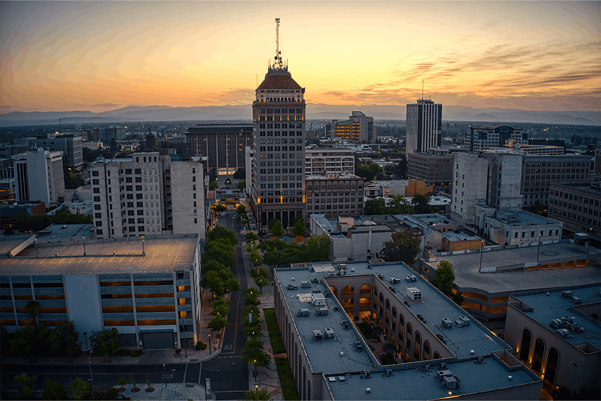 buildings in a city with a clock tower in the middle of the city