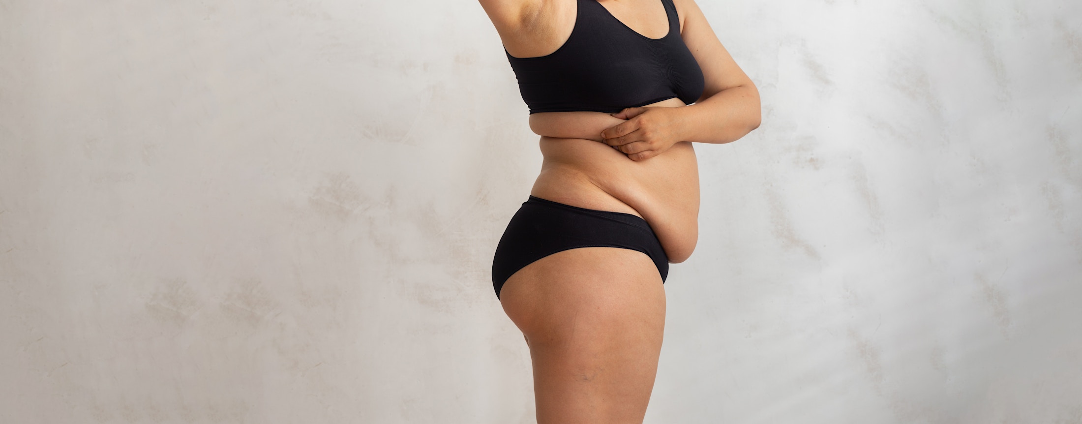 woman holding her torso