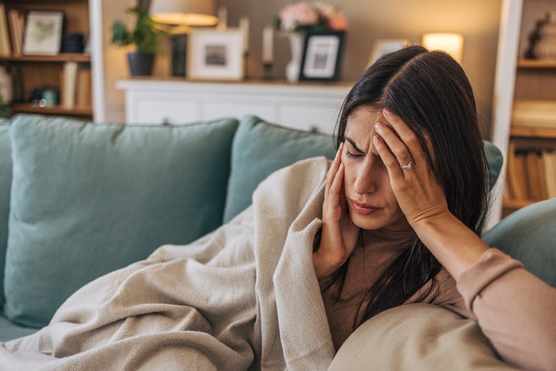 Woman holding her head in pain