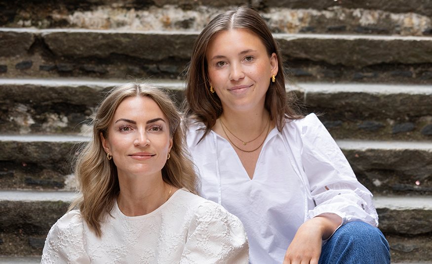 Two women sitting on stairway