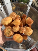 A bowl of seasoned, crispy roast potatoes