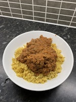 A bowl of meatball curry on a bed of pilau rice