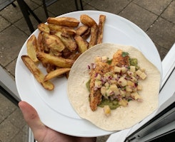 A plate of fish tacos and chips