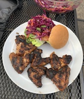 A plate of BBQ'd chicken wings and a burger