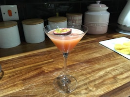 A glass of passion fruit martini