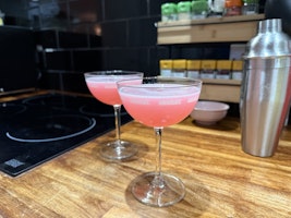 Two glasses of cosmopolitan in coupe glasses