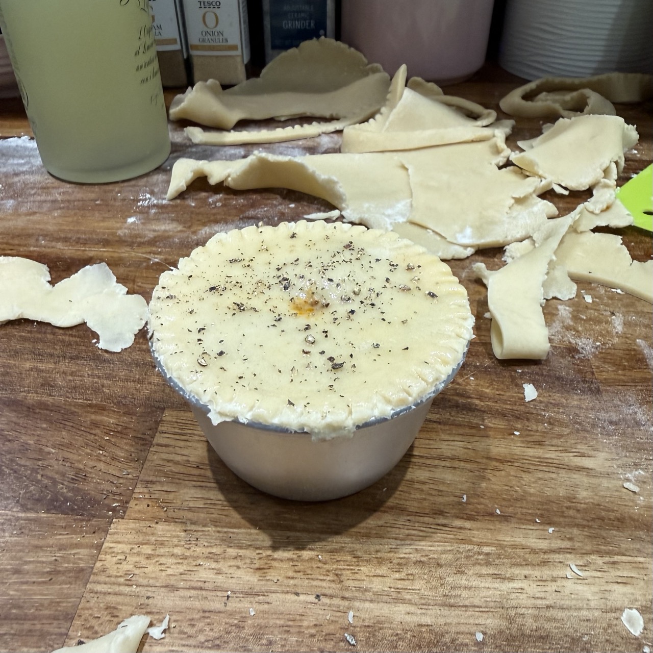 A prepped pie, ready for the oven. Topped with egg wash and freshly cracked black pepper.