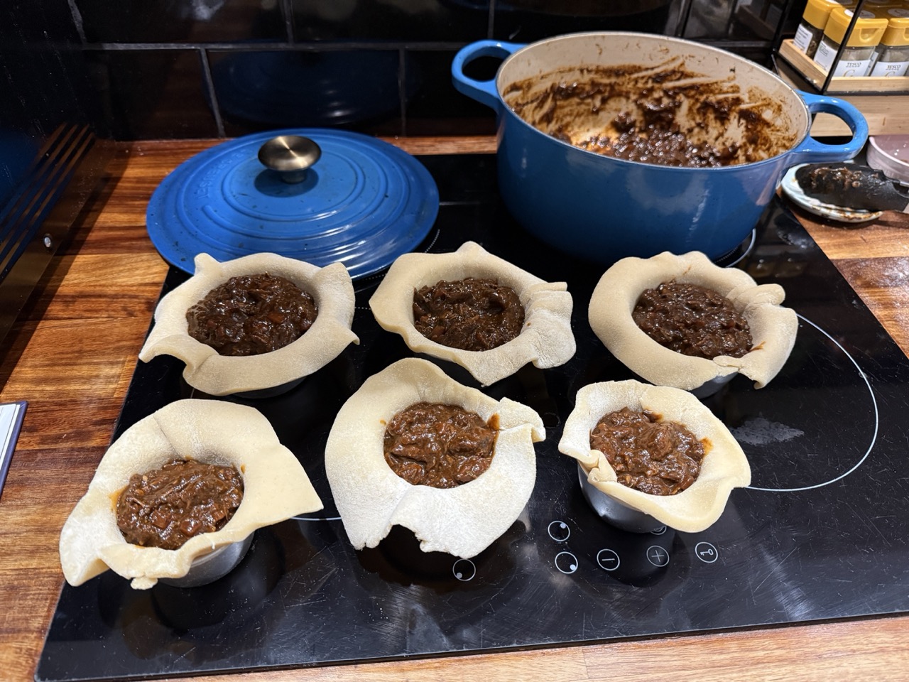 6 Braised beef pies with filling added and no lids