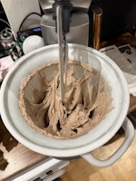 Chocolate hazelnut gelato being mixed in the stand mixer freezer bowl