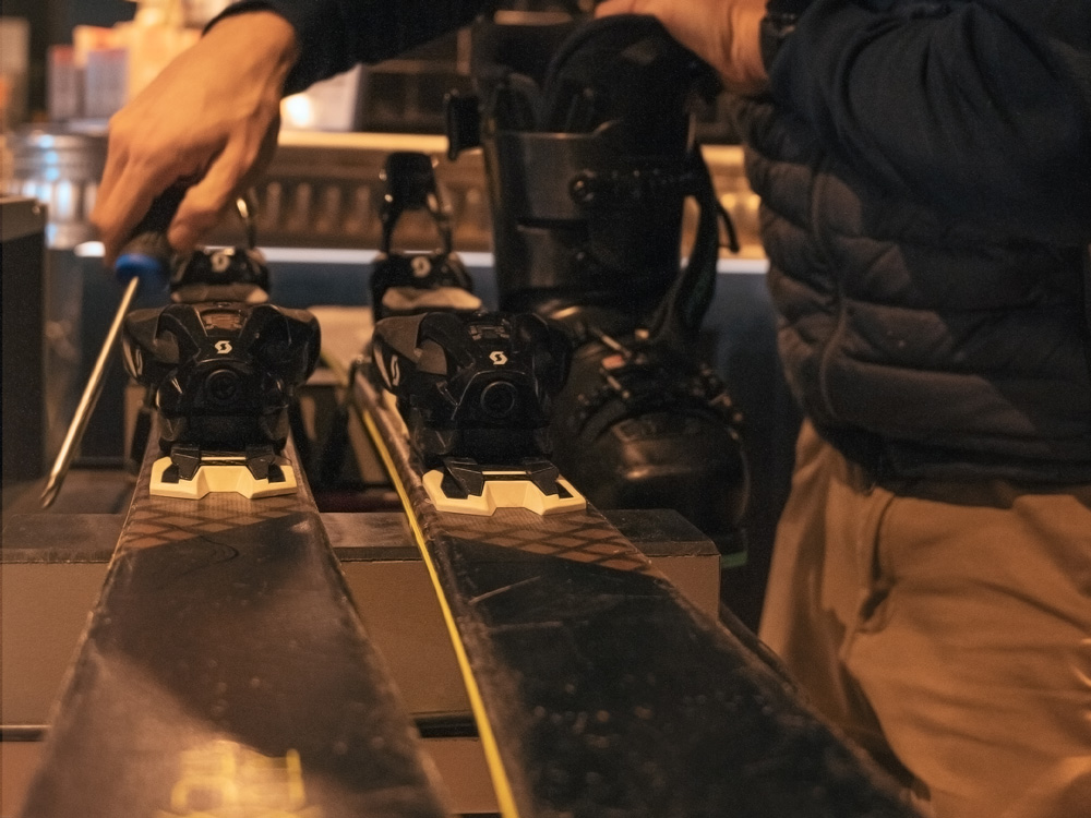 Close-up of alpine skis being set up and calibrated for optimal performance on the snow